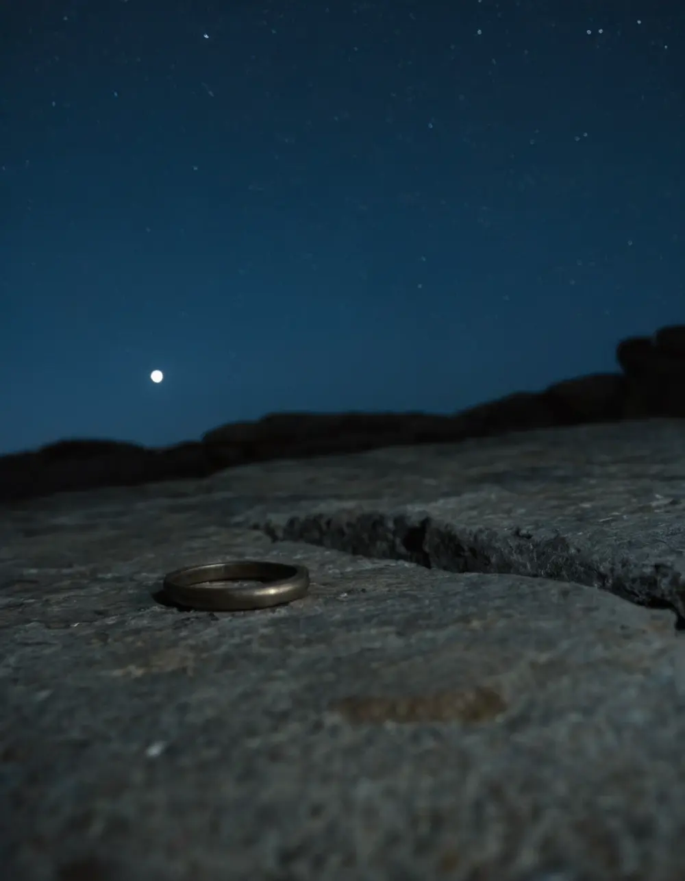 Shatabhisha: small metal ring on stone on a stone ledge at night